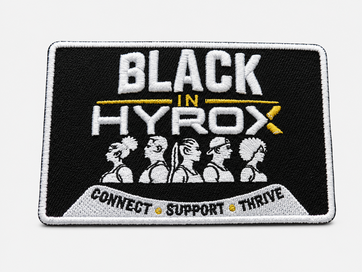 An embroidered rectangular patch with a black background, white border, and white text reading 'BLACK IN HYROX' with small yellow accents. Below the text are five white stylized figures and a curved banner at the bottom reading 'CONNECT SUPPORT THRIVE'.
